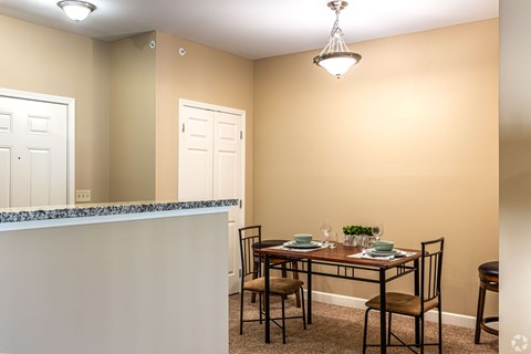 A dining room with a table set for two.