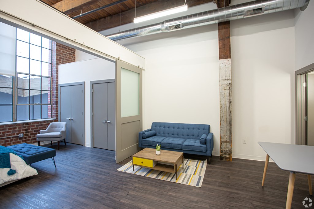 a living room with a blue couch and a coffee table
