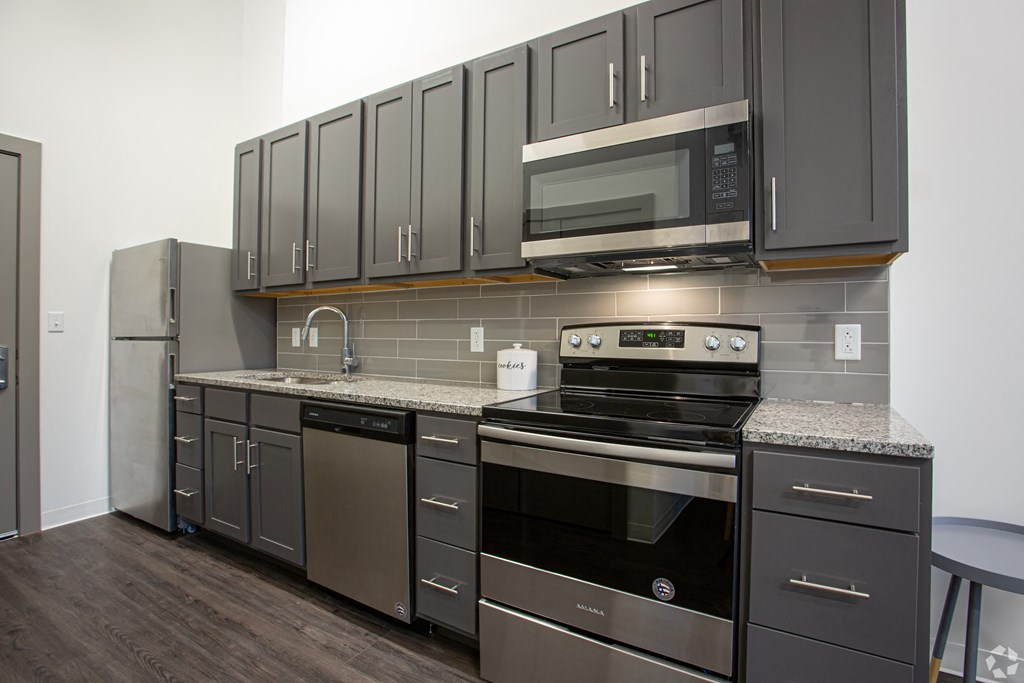 a kitchen with stainless steel appliances and granite counter tops