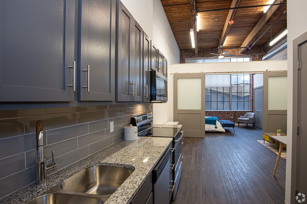 a kitchen with granite counter tops and stainless steel appliances
