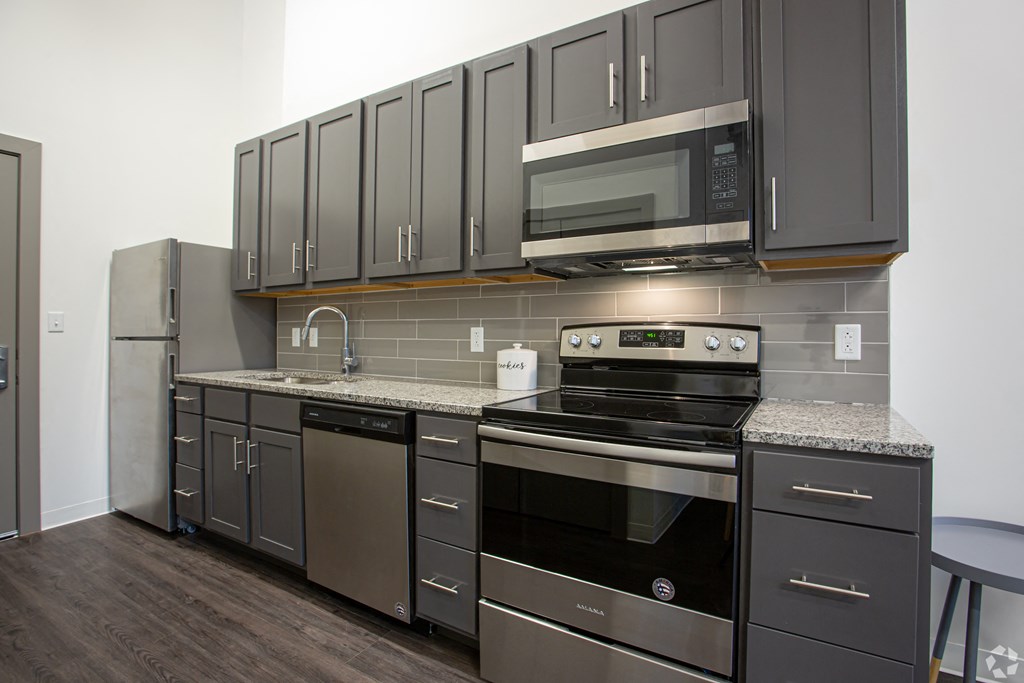 a kitchen with stainless steel appliances and granite counter tops