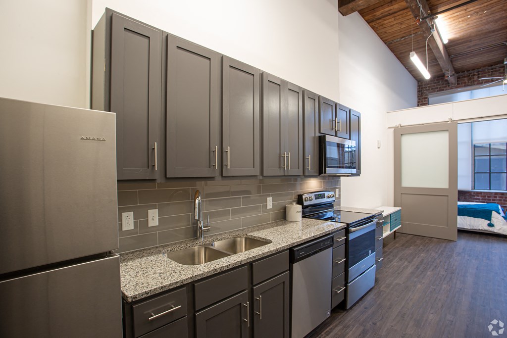 a kitchen with granite counter tops and stainless steel appliances