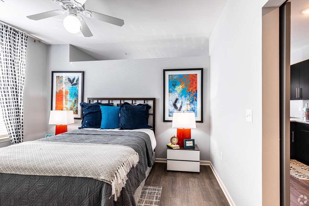 a bedroom with a bed and a ceiling fan  at Waterside Residences on Quivira, Lenexa, Kansas