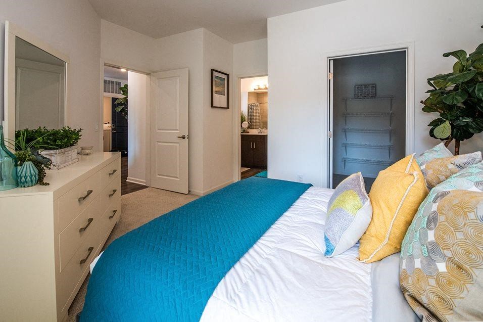 Bedroom with cozy bed and cupboards at 44 Washington, Kansas City, MO