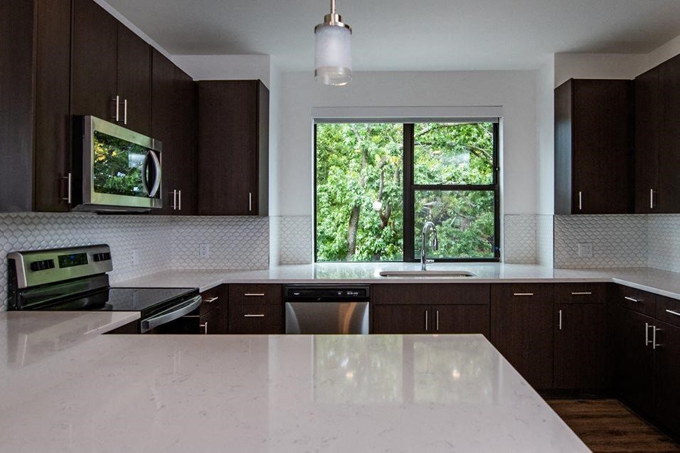 Wooden cabinets in kitchen with appliances at 44 Washington, Kansas City, MO