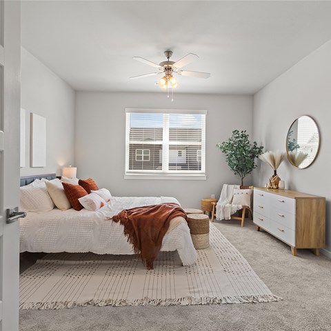 a bedroom with a bed and a ceiling fan at Hillcrest Village, Springdale, AR