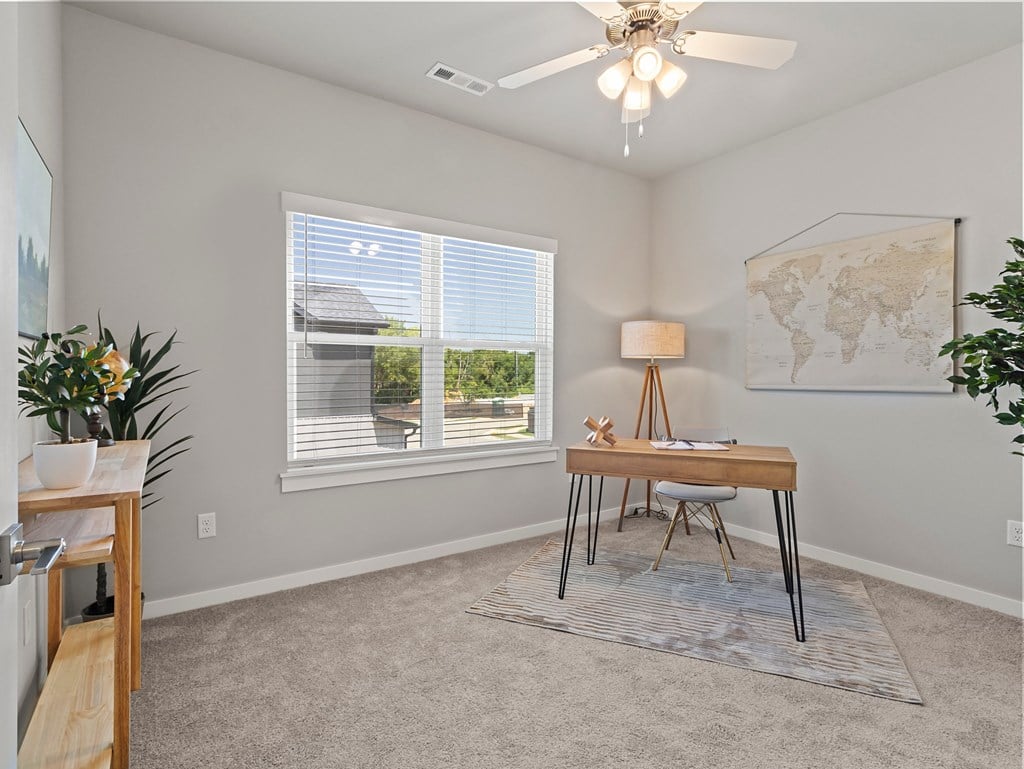 an office with a desk and a window and a ceiling fan at Hillcrest Village, Arkansas, 72762