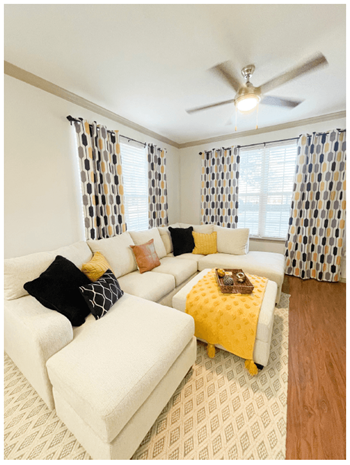 a living room with a white couch and a yellow ottoman - Photo Gallery 25