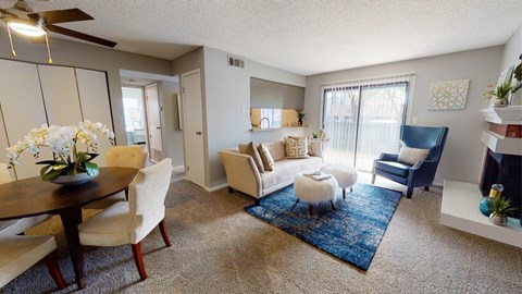 A living room with a dining table and chairs.