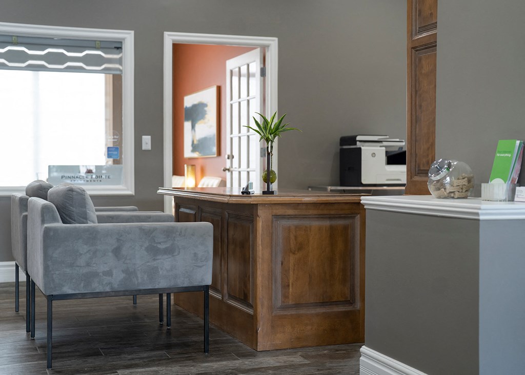 a home office with a desk and chairs