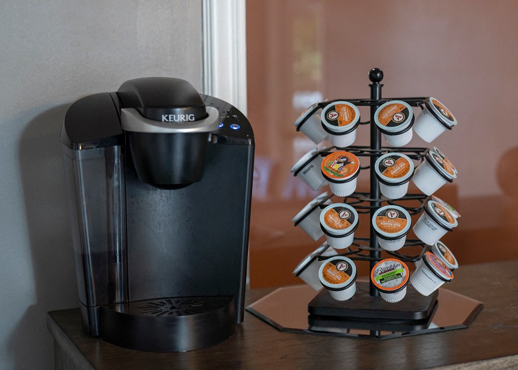 a coffee maker and coffee cups on a table
