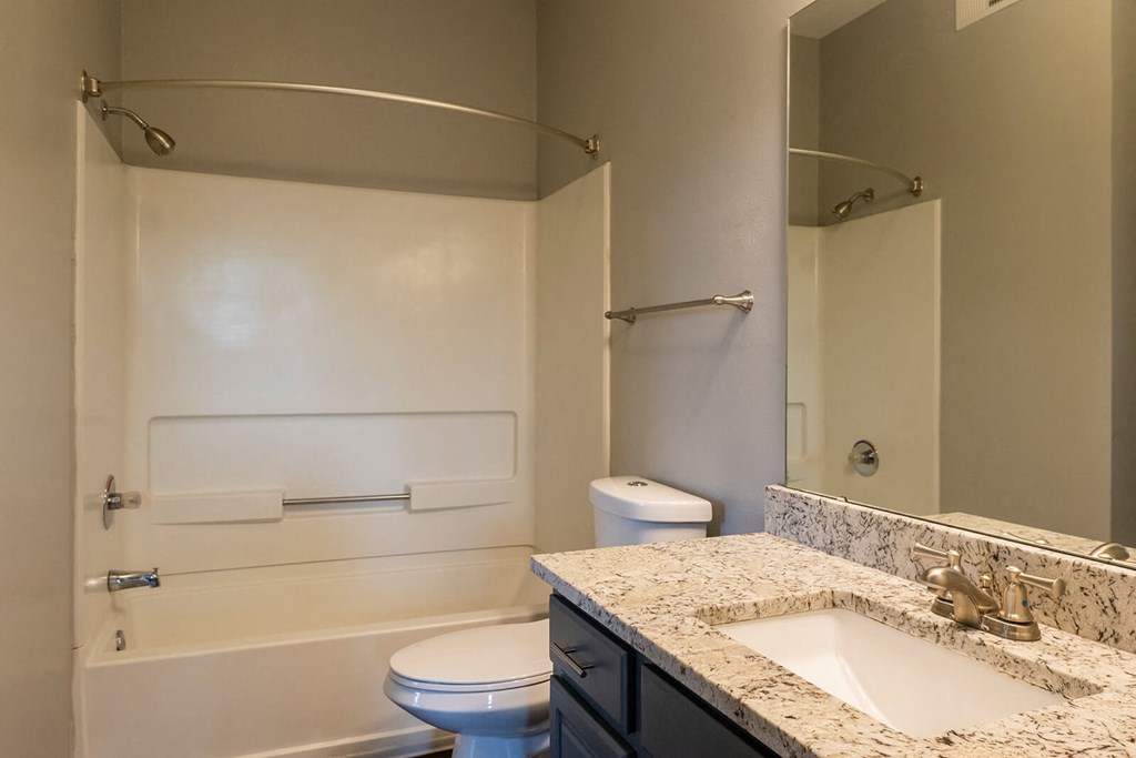 a bathroom with a toilet sink and bathtub