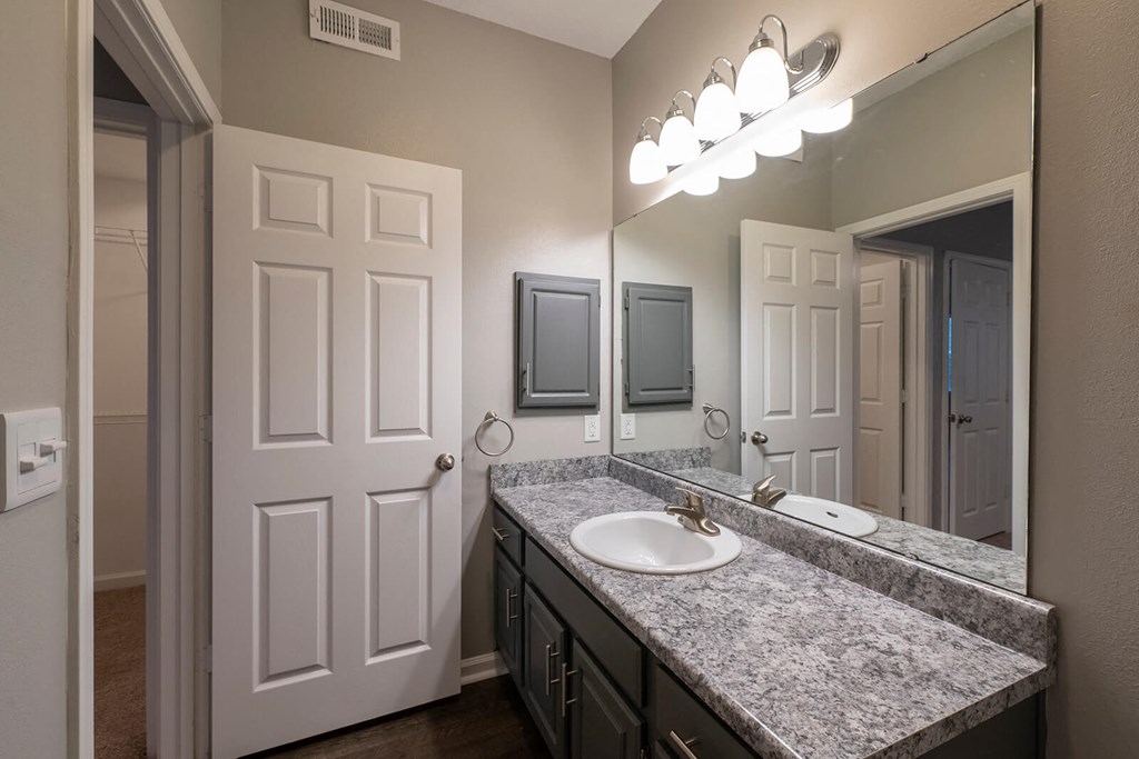 a bathroom with sink and grey walls