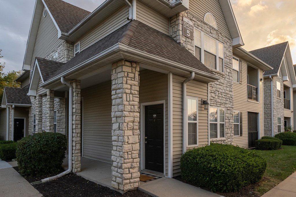 a picture of a house with a stormy sky in the background