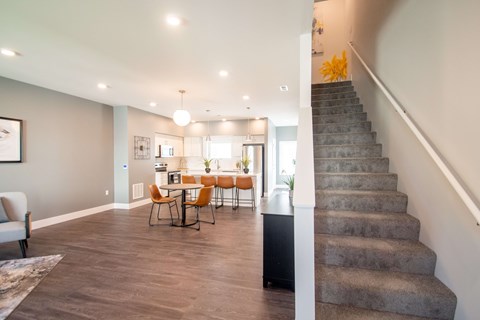 A living room with a dining table and chairs.