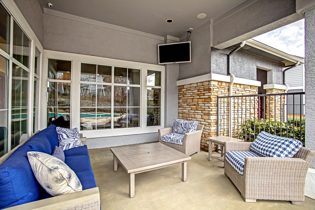 outdoor seating area with patio furniture and tv screen