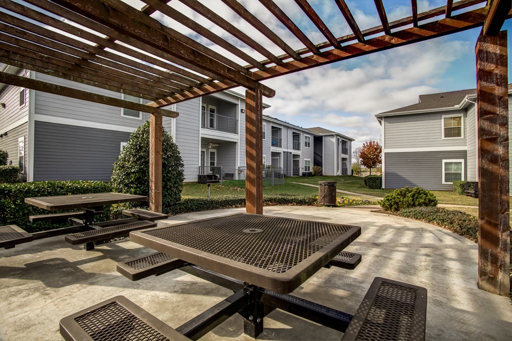outdoor seating area under pergola with landscaping