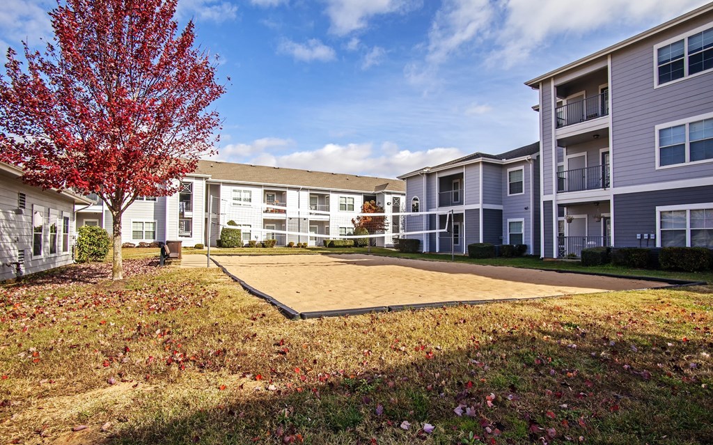 sand volleyball court behind mailroom and package delivery room