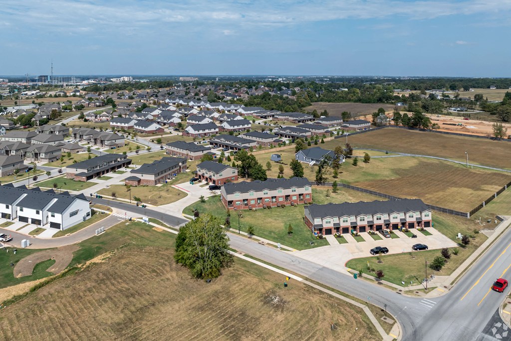 A suburban neighborhood with houses and a road.
