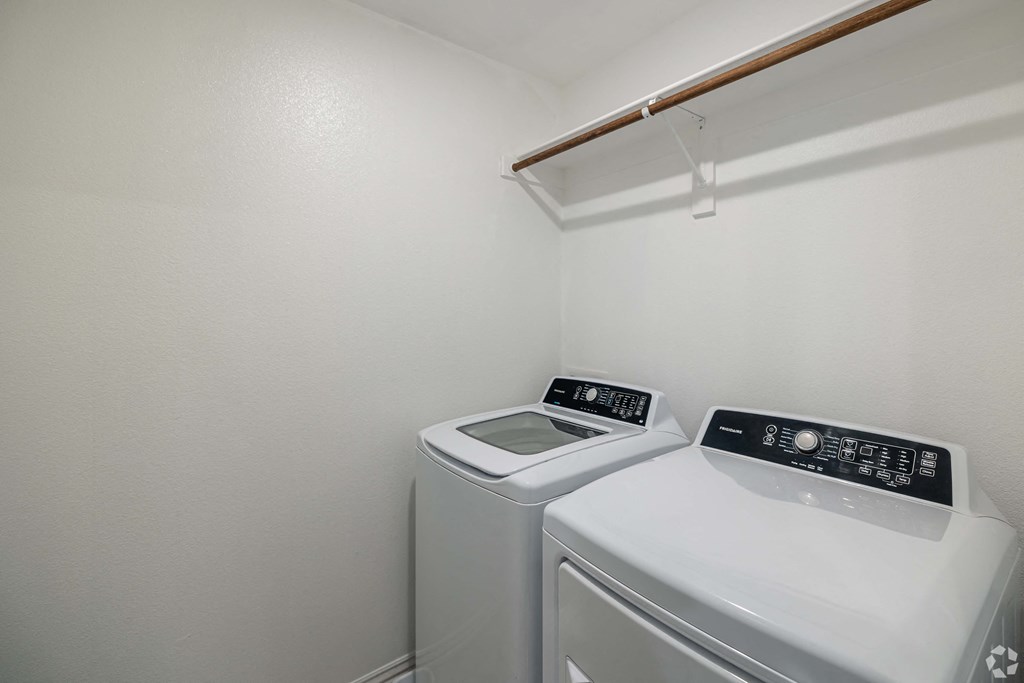 A small laundry room with a washer and dryer.