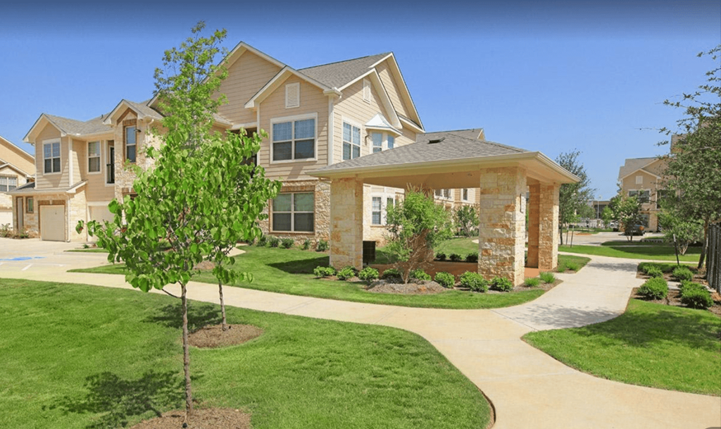 an image of a house with a sidewalk in front of it