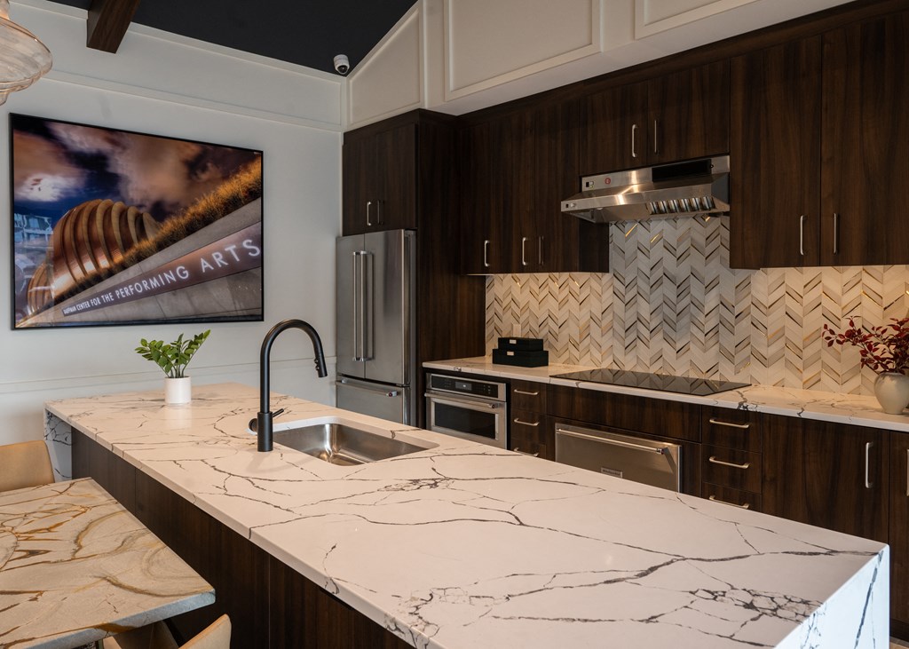 a kitchen with marble counter tops and a sink  at The Clearing at ONE28, Kansas, 66062