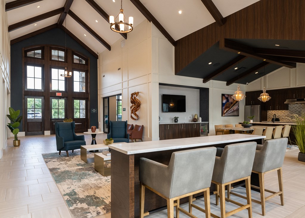a large lobby with a bar and a living room  at The Clearing at ONE28, Kansas
