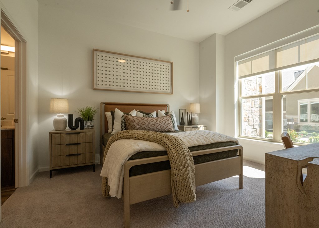 a bedroom with a bed and a large window a bedroom with a bed and a large window at The Clearing at ONE28, Kansas