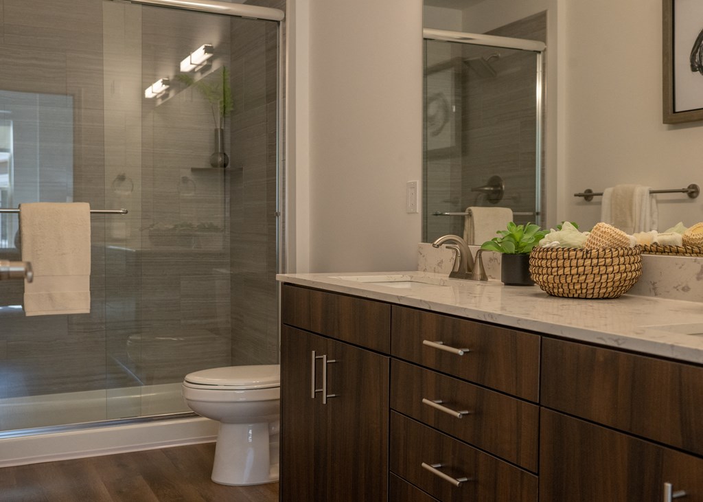 an image of a bathroom with a shower and a toilet  at The Clearing at ONE28, Olathe, Kansas