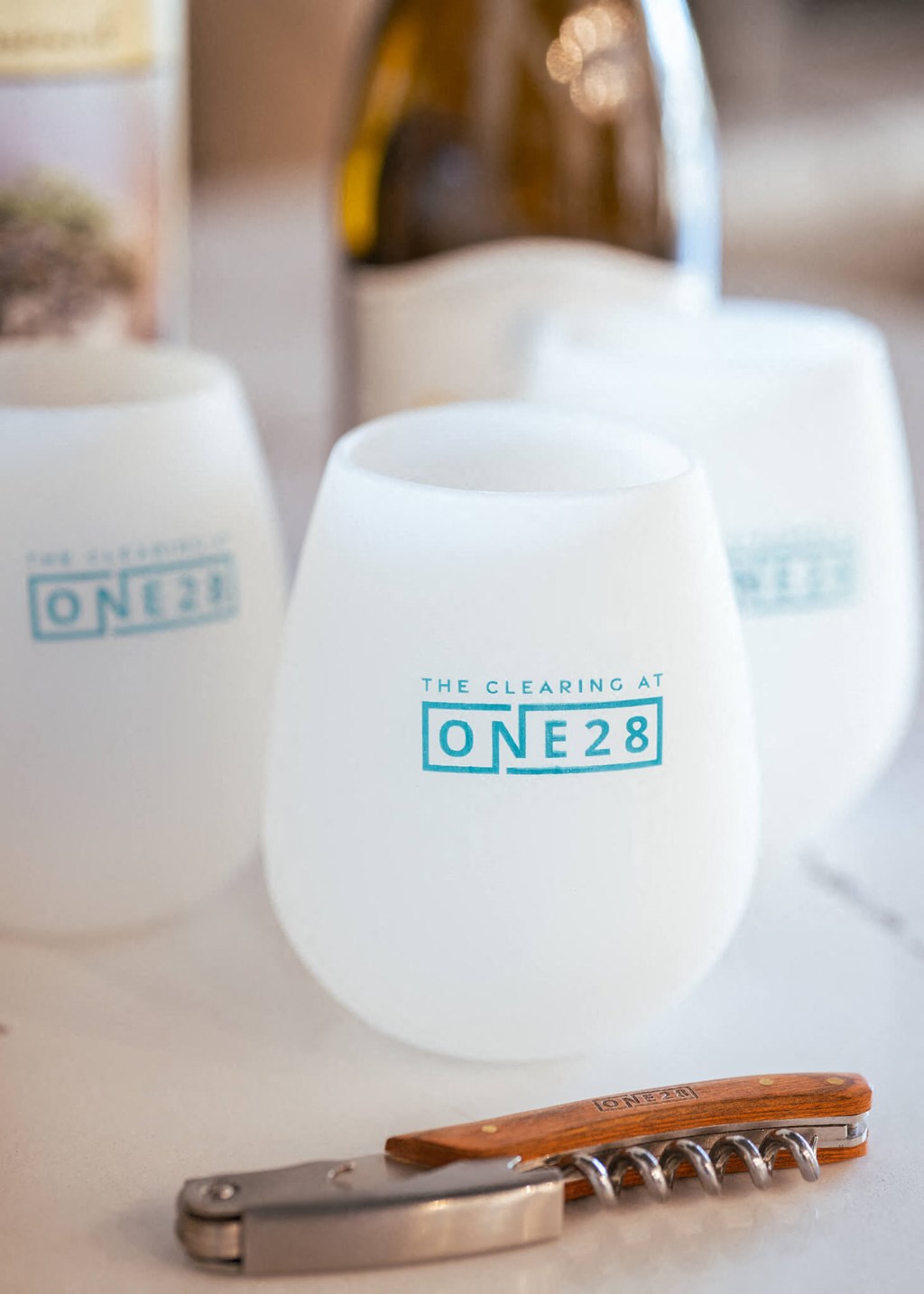 two white vases with blue writing on them and a wooden comb on a table