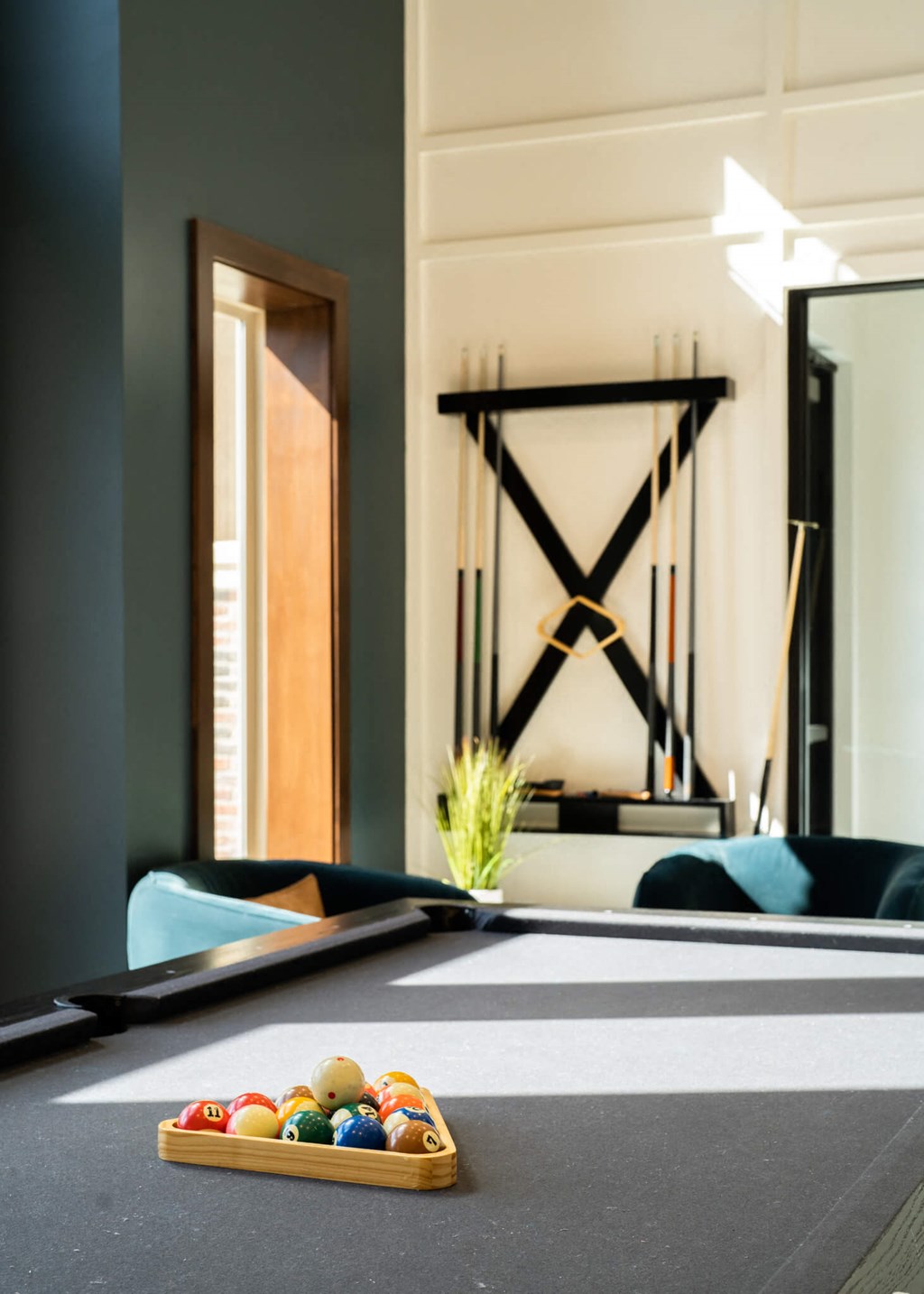 a pool table in a room with a tray of balls