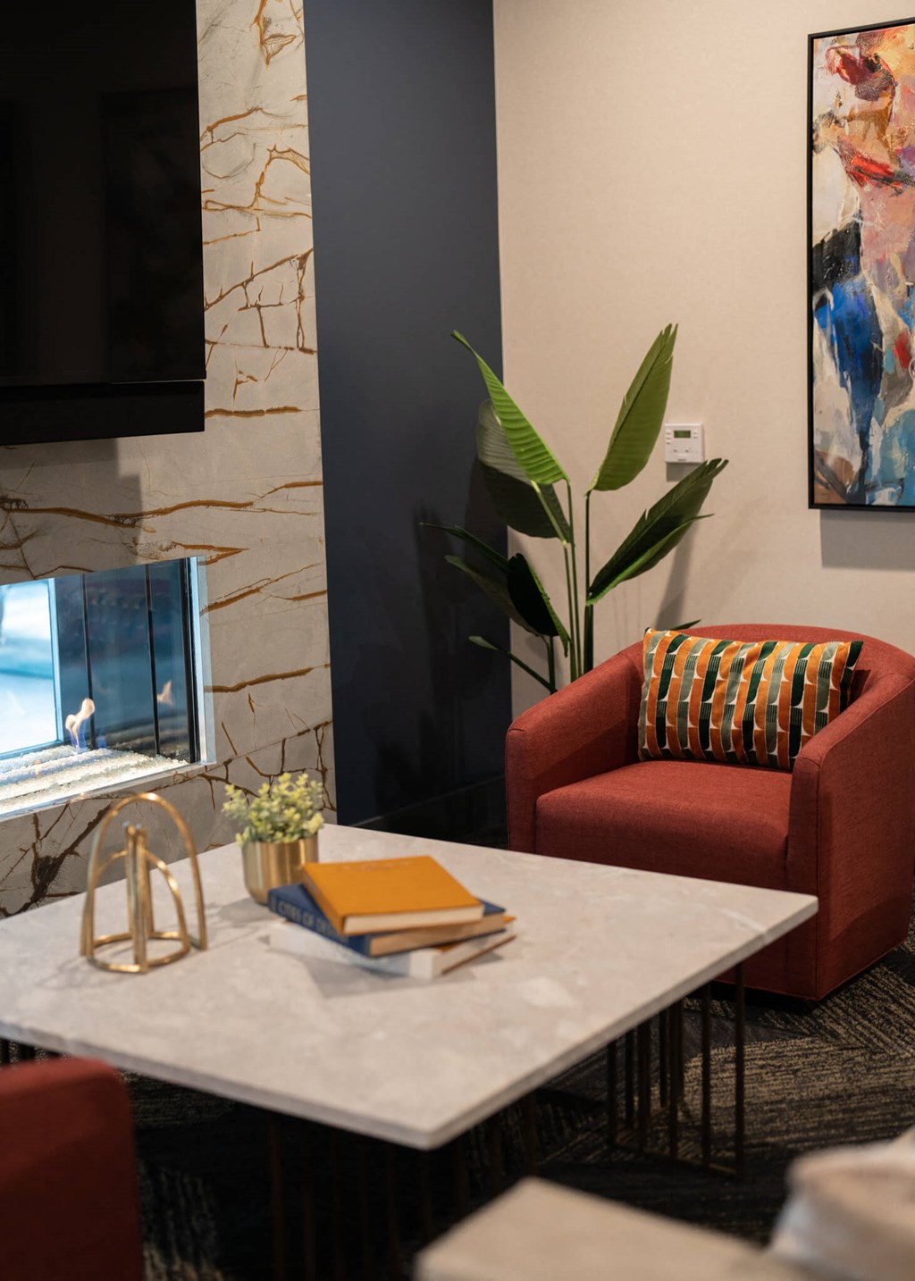 a living room with a table and chairs and a computer