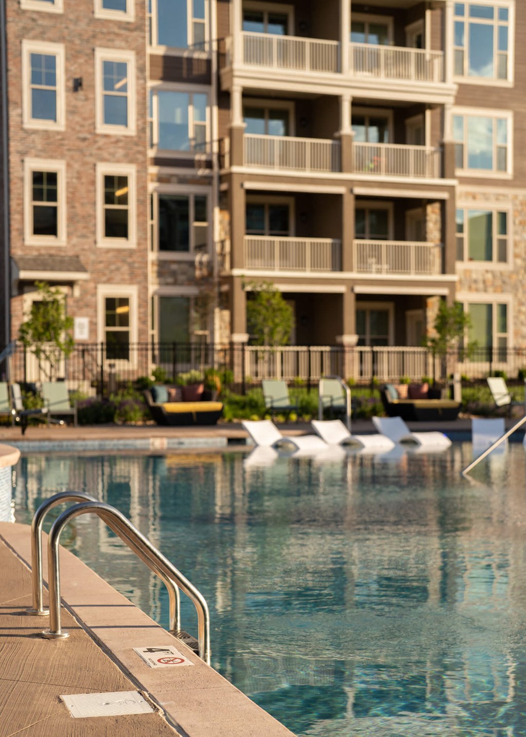 a swimming pool in front of an apartment building