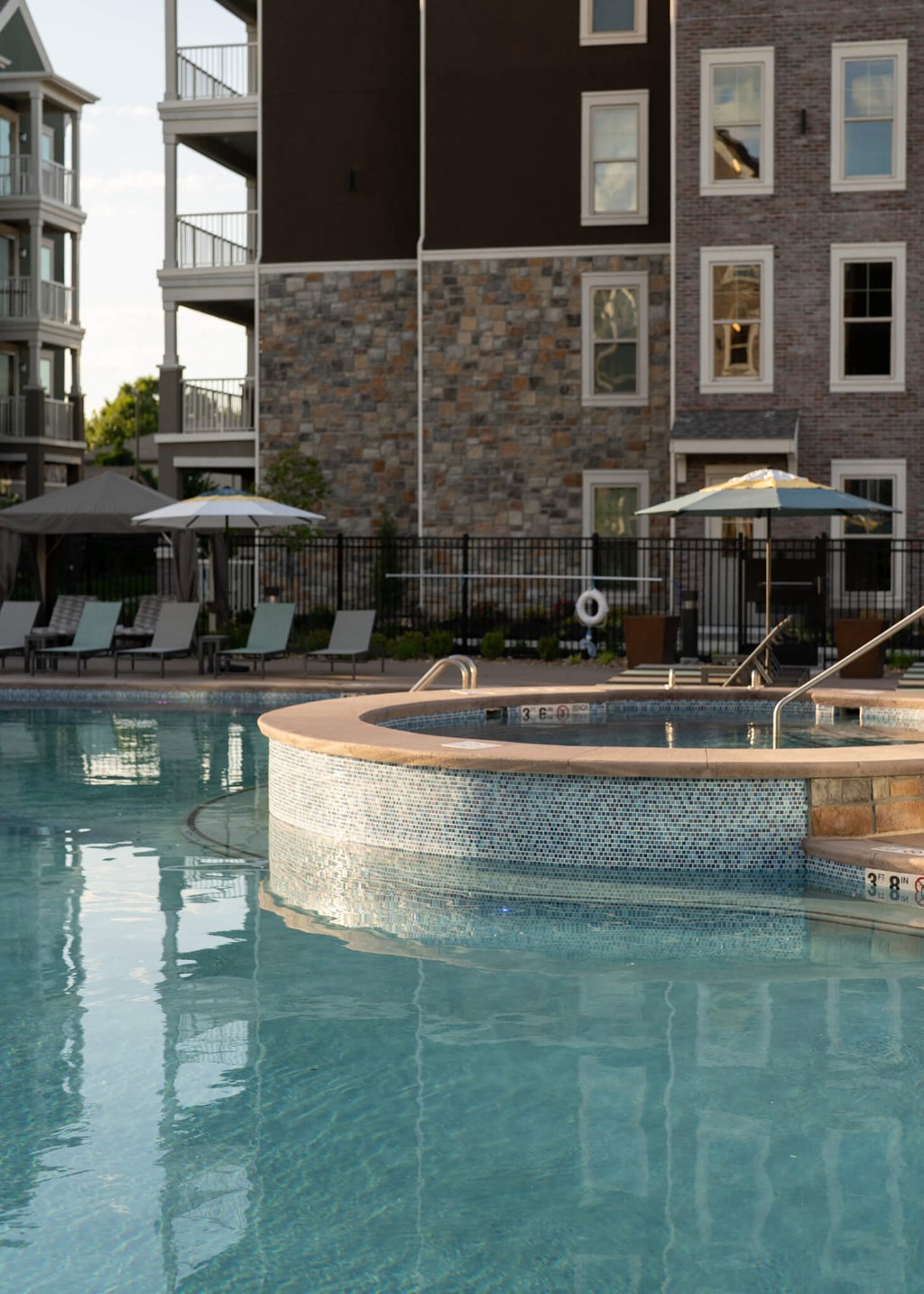 a large swimming pool with a building in the background