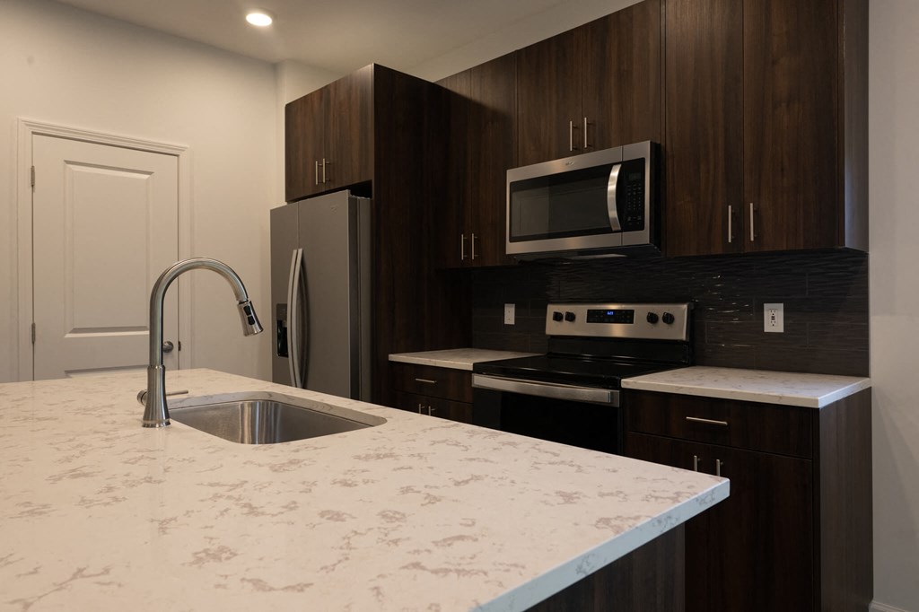 a kitchen with a marble counter top and a sink