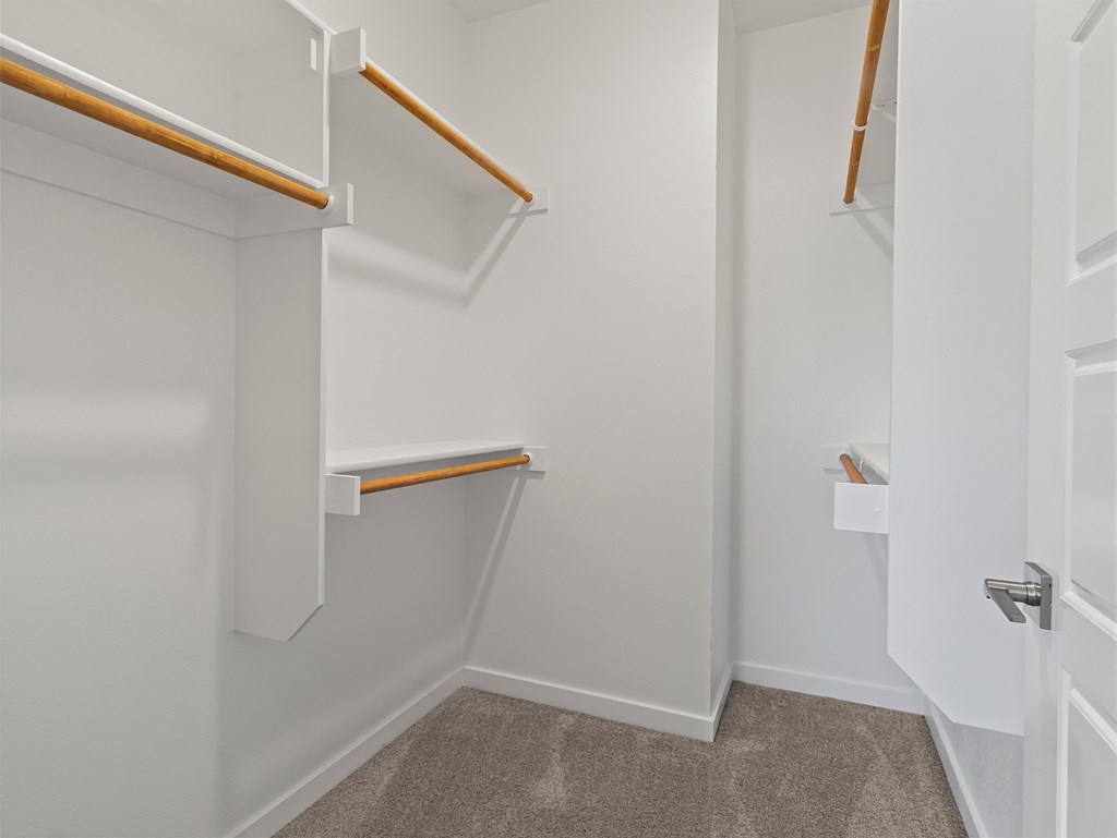a walk in closet with shelves and a door at Hillcrest Village, Arkansas