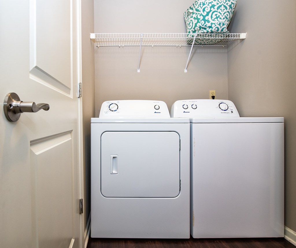 A white washing machine and dryer in a small laundry room.