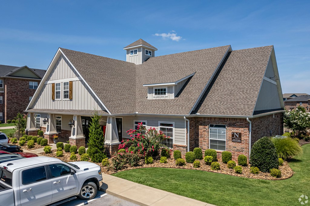 a suburban house with a yard and a parking lot