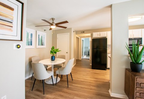 A dining room with a white table and chairs.
