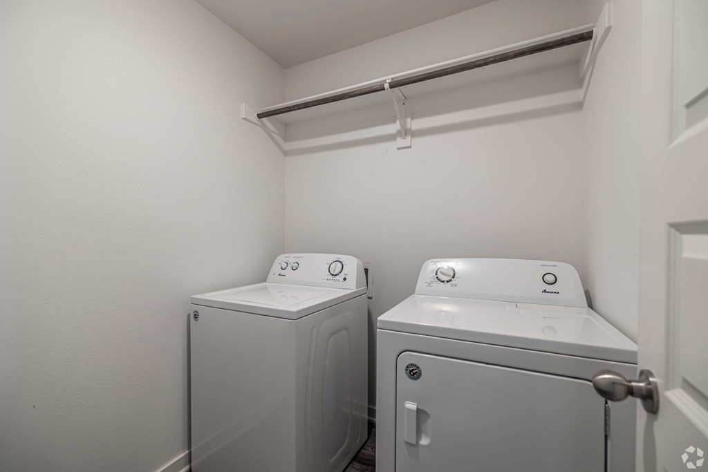 A small laundry room with a washer and dryer.