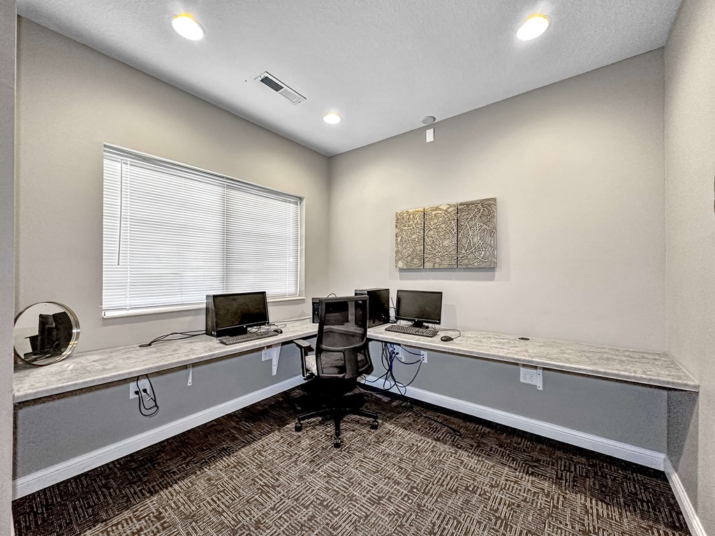 A room with two desks and a computer on each.