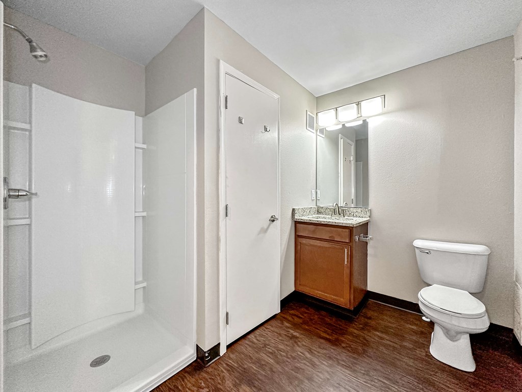A white toilet sits next to a sink in a bathroom.