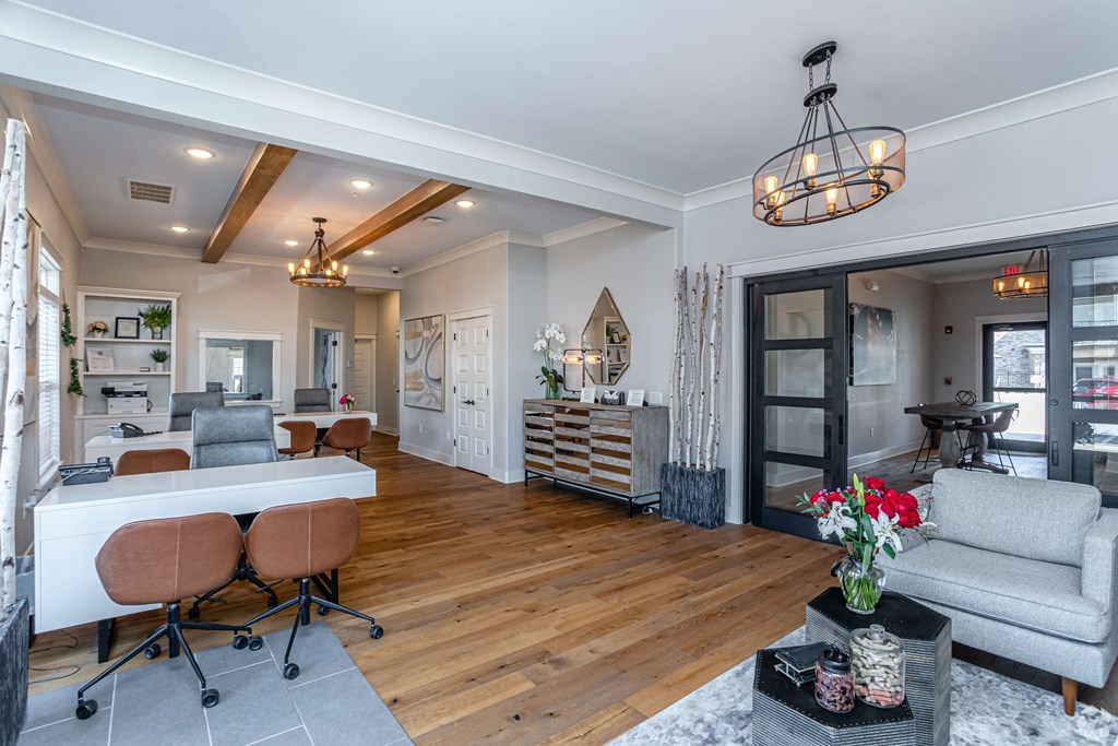 a living room and dining room with a table and chairs