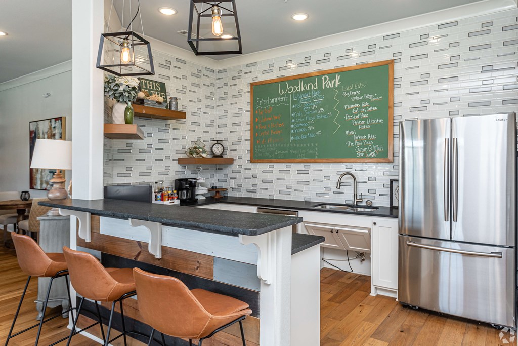 a kitchen with a large counter and a chalkboard on the wall