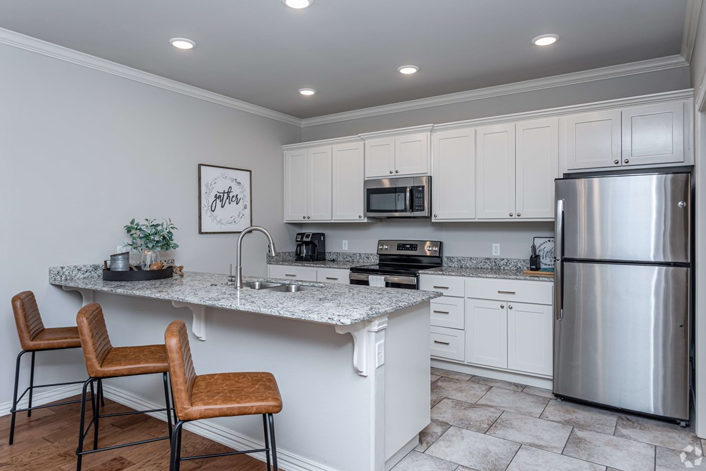 a kitchen with stainless steel appliances and a granite counter top