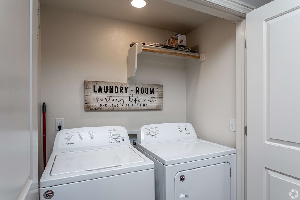 a laundry room with two washes and a dryer