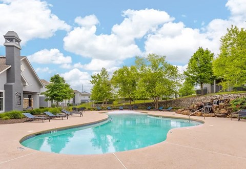 sparkling swimming pool with outdoor seating area