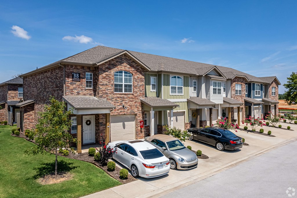 a large house with cars parked in front of it