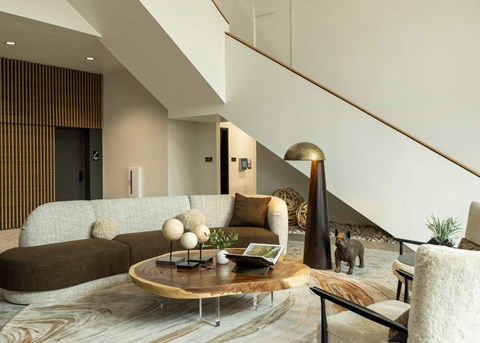 A modern living room with a brown couch and a wooden coffee table.