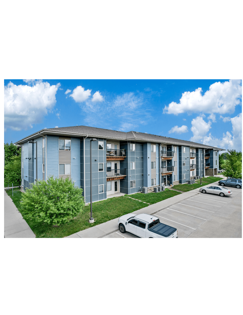 A car is parked in the parking lot of a building.